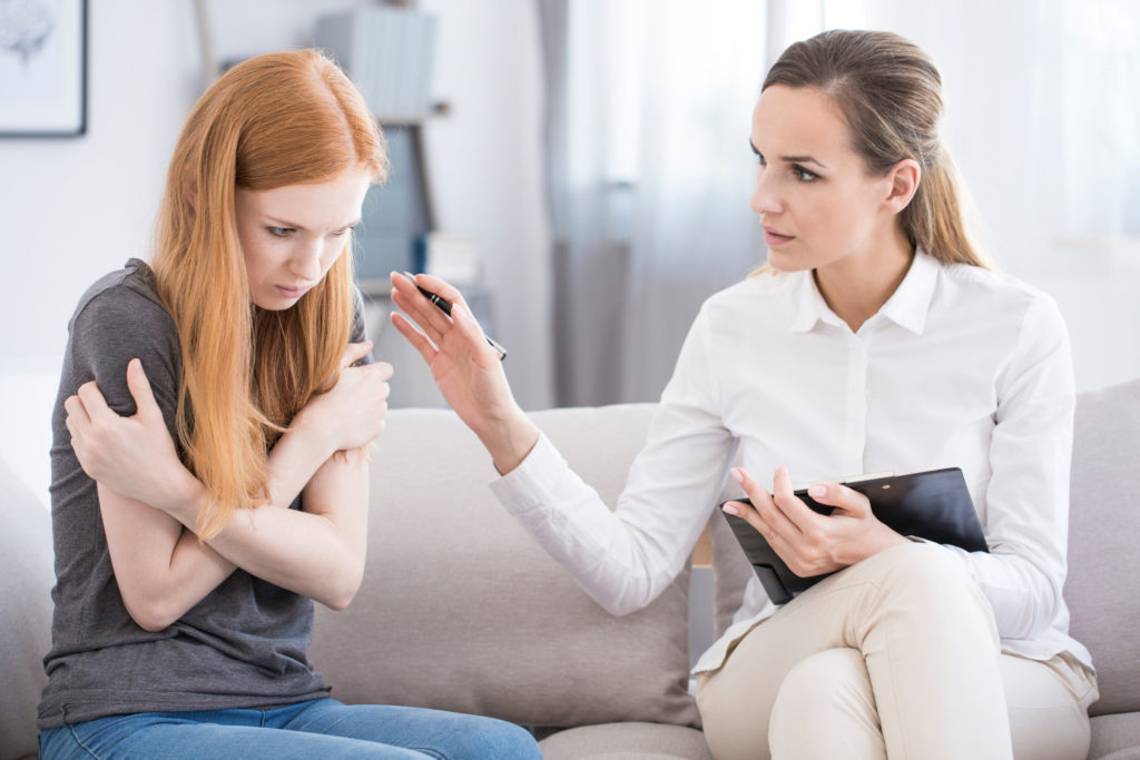 Psychotherapist reassuring teenager with anxiety
